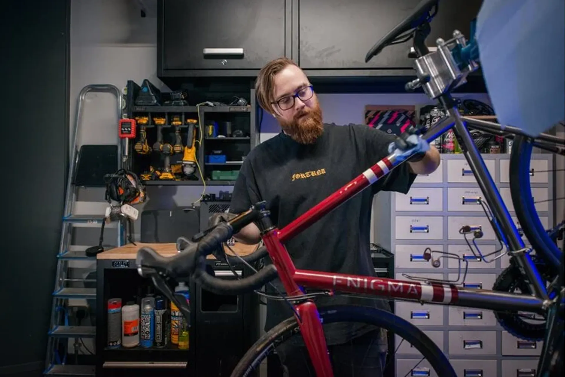 A mechanic working on a bicycle in the Edinburgh Bike Fitting workshop