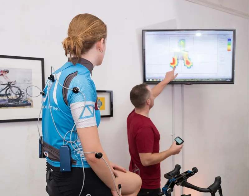 A cyclist being assessed off the bike