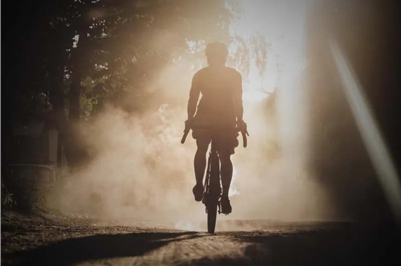 A rider in silhouette in early morning light