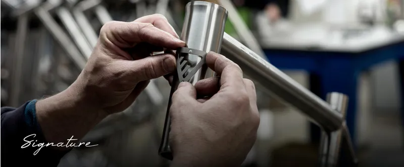 An Enigma Ti badge being fitted to a Signature frame in the workshop