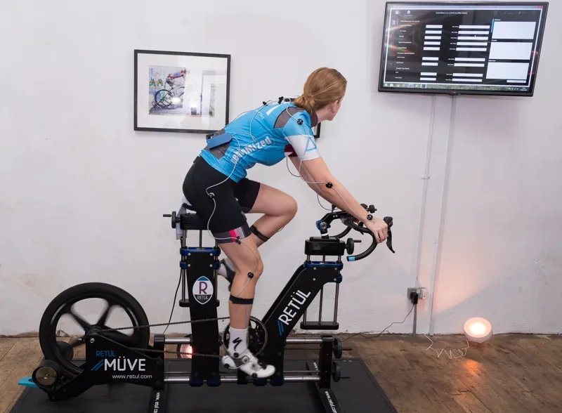 A cyclist on a bike trainer being fitted